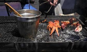 Lobster on a barbecue grill being prepared photo