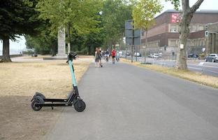 Dusseldorf, Germany - August 30, 2019 - E-mobility in Germany. E-scooters waiting for customers next to a street in Dusseldorf, Germany. photo