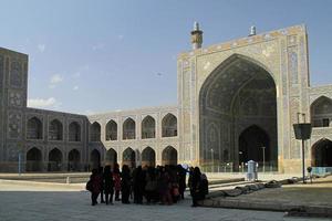 Isfahan, Iran - June 15, 2018 - A group of young women gets together on the square of Jameh Mosque in Isfahan, Iran, on a sunny day. photo