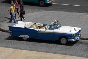 Havana, Cuba - July 2, 2019 - Taxi driver and their classic cars in Havana, Cuba. photo