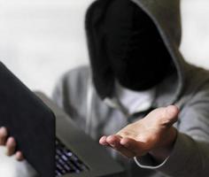 Ransomware - Hacker with laptop demanding money photo