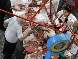 Almaty, Kazakhstan - August 24, 2019 - Workers in the meat section of the famous Green Bazaar in Almaty, Kazakhstan photo