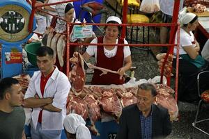 Almaty, Kazakhstan - August 24, 2019 - Workers in the meat section of the famous Green Bazaar in Almaty, Kazakhstan photo