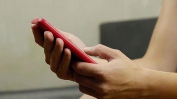 woman hand writing a message on a red phone closeup. High quality FullHD footage video