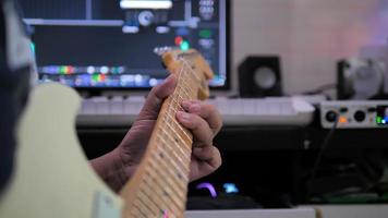 Musician artist playing guitar to record in sound mixing studio process of music creation video