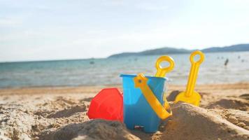 Toys on the sand beach with sea wave select focus shallow depth of field with summer atmosphere video