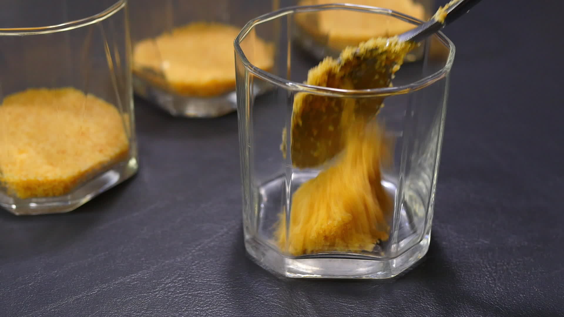 Closeup pressing cracker process in container for making banoffee