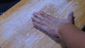 person kneading dough preparing for making bread, homemade bakery cooking in kitchen concept