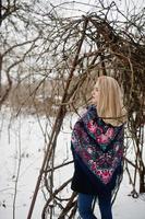 Blonde girl with hand embroidered scarf posed at winter day. Women's handkerchief. photo