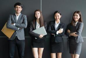 Portrait of Asian business people posing in office building photo