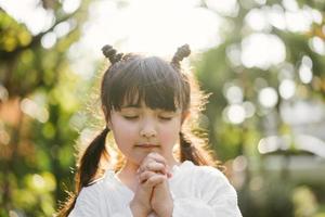 little girl praying. kid prays photo