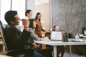 Group of Asian business people team meeting in modern office working design planning and ideas concept photo