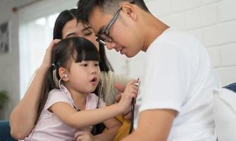 Daughter playing as doctor with family photo