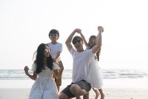Asian Family walking at beach with kids happy vacation concept photo