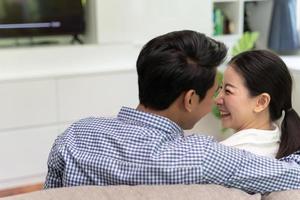 Romance Asian couple watching television at home. photo