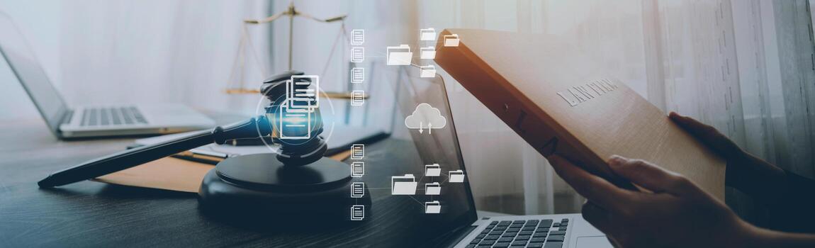 Justice and law concept.Male judge in a courtroom with the gavel, working with, computer and docking keyboard, eyeglasses, on table in morning light photo