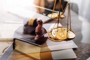 Justice and law concept.Male judge in a courtroom with the gavel, working with, computer and docking keyboard, eyeglasses, on table in morning light photo