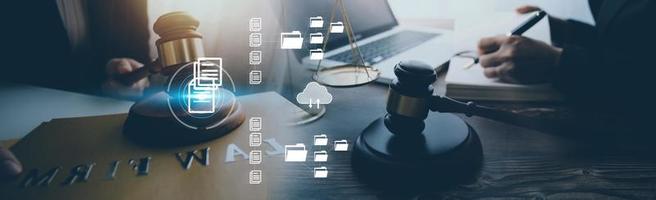 Justice and law concept.Male judge in a courtroom with the gavel, working with, computer and docking keyboard, eyeglasses, on table in morning light photo