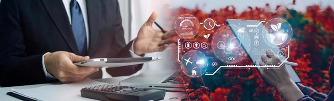 Selective focus. Architect team planning design apply renewable or solar energy on architectural building model with virtual reality technology hologram. Alternative green energy in future concept. photo
