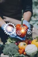 Futuristic businessman farms vegetables and crops using modern AI technology using mobile phones, temperature and humidity sensors, water tracking, climate control, holographic data data icons. photo