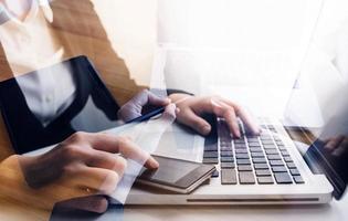 Businessman and team analyzing financial statement Finance task. with smart phone and laptop and tablet. Wealth management concept photo