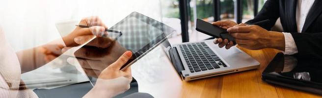 Businessman and team analyzing financial statement Finance task. with smart phone and laptop and tablet. Wealth management concept photo