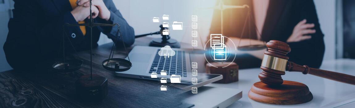 Justice and law concept.Male judge in a courtroom with the gavel, working with, computer and docking keyboard, eyeglasses, on table in morning light photo