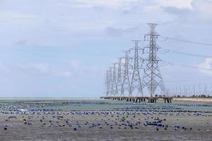 High voltage power pole in the sea photo