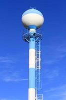 Water tower against blue sky photo