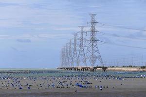 High voltage power pole in the sea photo