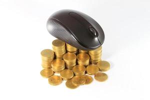 black  computer mouse and golden coin photo