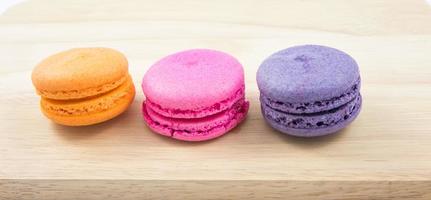 Colorful macaroons variety closeup on wood background photo