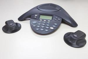 Conference IP phone on white table background photo