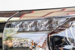 Closeup LED headlights daylight running of modern white car photo