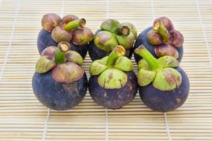 Mangosteen queen of fruits on traditional mat is most popular in Thailand and International photo