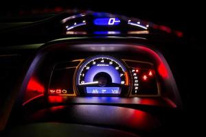 Modern car instrument dashboard panel and digital speed meter full symbol in night time photo
