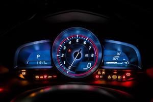 Modern car instrument dashboard panel or speedometer and full symbol in night time photo