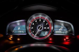 Modern car instrument dashboard panel or speedometer in night time