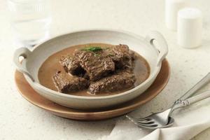 Empal Daging Kelem, Traditional Beef Stew from Central Java, Indonesia. Made from Beef, Coconut Milk, and Various Spices. photo