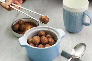 Close Up Semur Telur Puyuh  is Boiled Eggs Cook with Soy Sauce for Family Menu photo