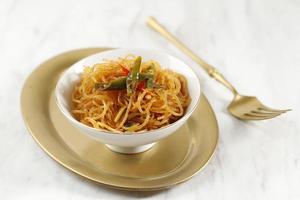 Spicy Fried Glass Noodle or Bihun Goreng Pedas, Stir Fry Vermicelli with Chilli, Garlic, Shallot, and Sweet Soy Sauce. Indonesian Side DIsh Popular Menu. photo