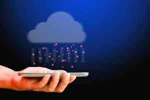 Cloud data storage concept. Hand hold cloud computing with transfer arrow on blue background. Communication of business and financial. Large database and synchronize with the internet and technology. photo