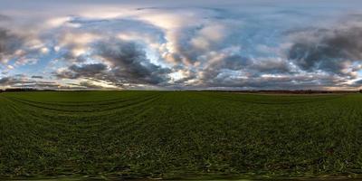 full seamless spherical hdri panorama 360 degrees angle view among fields in evening sunset with awesome blue pink red clouds in equirectangular projection, ready for VR AR virtual reality photo