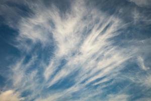 Blue sky background with tiny stratus cirrus striped clouds. Clearing day and Good windy weather photo