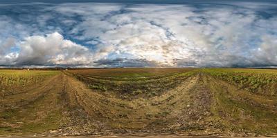 full seamless spherical hdri panorama 360 degrees angle view among fields in autumn sunny evening with awesome clouds in equirectangular projection with zenith and nadir, ready for VR virtual reality photo