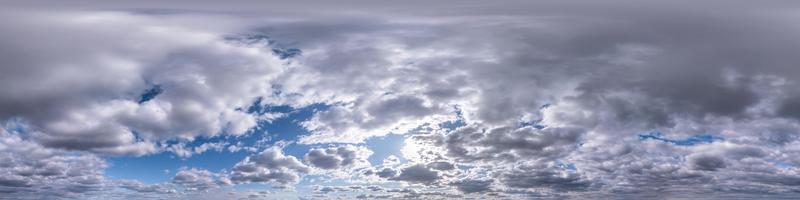 Seamless hdri panorama 360 degrees angle view blue sky with beautiful evening fluffy cumulus clouds without ground for use in 3d graphics or game development as sky dome or edit drone shot photo