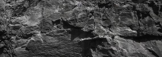 fondo de textura de pared de roca de piedra negra foto