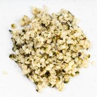pile of cores of hemp seeds close up on gray photo