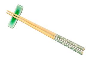 top view of decorated chopsticks on chopstick rest photo
