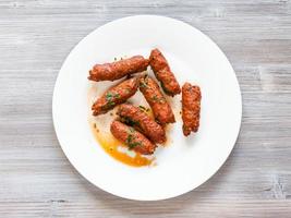 Mutton Seekh Kabab on white plate on board photo